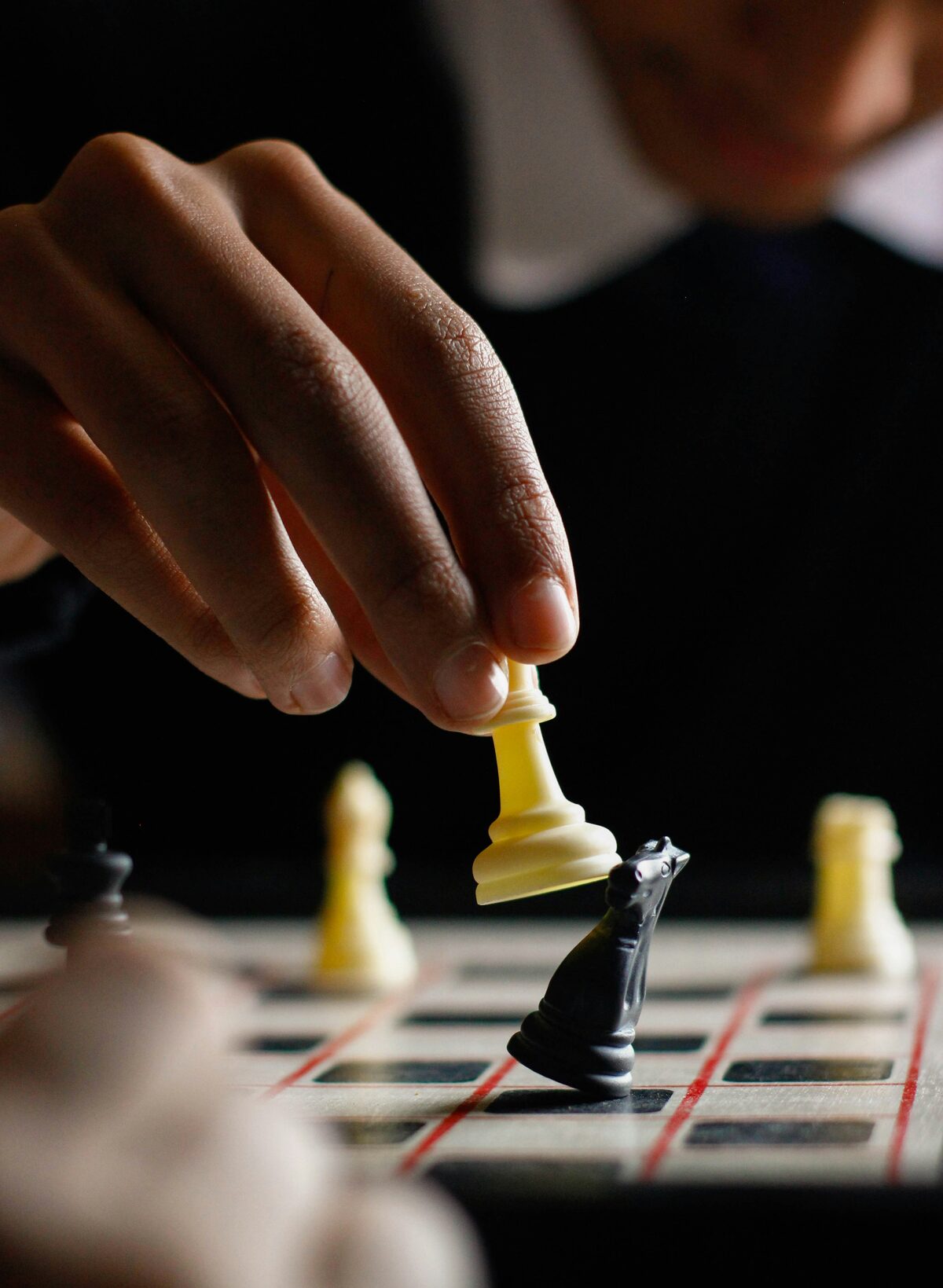 Chess board and pieces, with players.