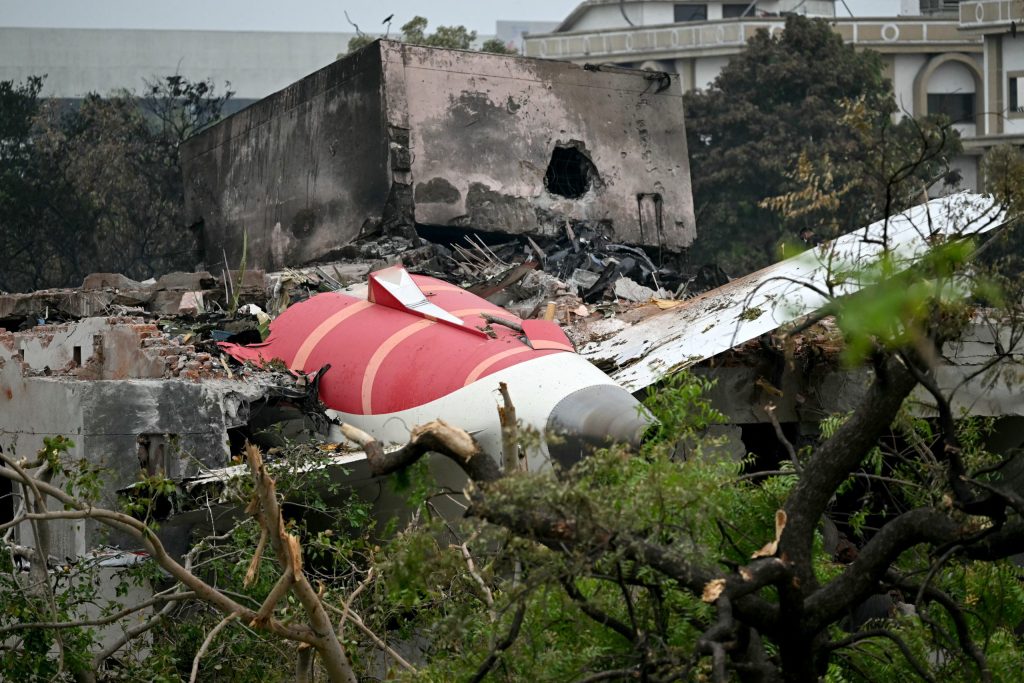 TOPSHOT - Debris of Air India flight 171 is pictured after it crashed in a residential area near the airport in Ahmedabad on June 13, 2025. Rescue teams with sniffer dogs combed the crash site on June 13 of a London-bound passenger jet which ploughed into a residential area of India's Ahmedabad city, killing at least 265 people on board and on the ground. (Photo by Punit PARANJPE / AFP)
