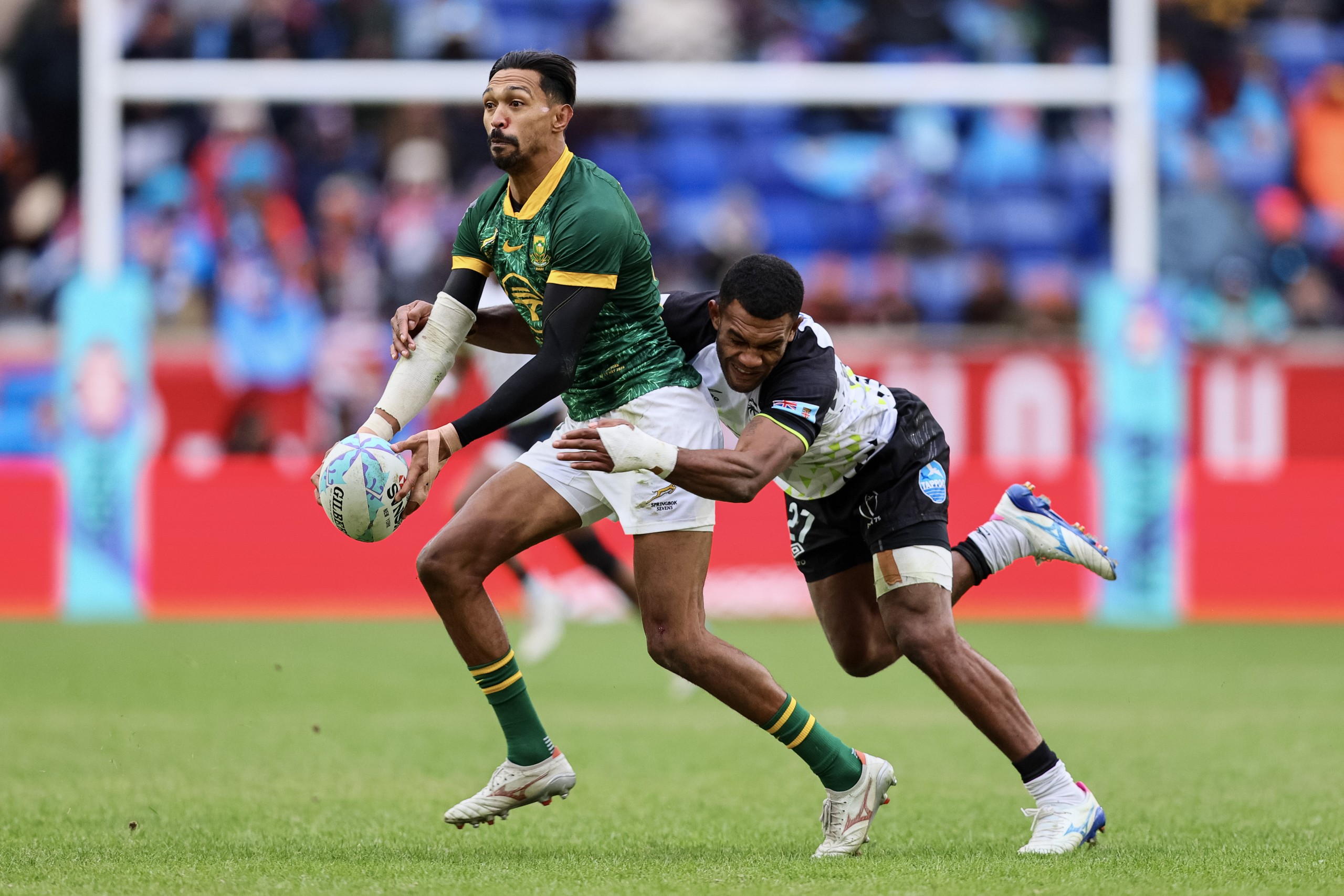 Blitzbok Tristan Leyds carries the ball as Douglas Daveta of Fiji attempts a tackle.