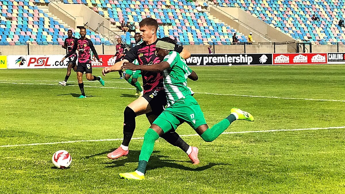 Allan Keegan of AmaZulu (in black) and Ohizu Chibuke of Siwelele FC in a tight chase for the ball during a Premiership league fixture.