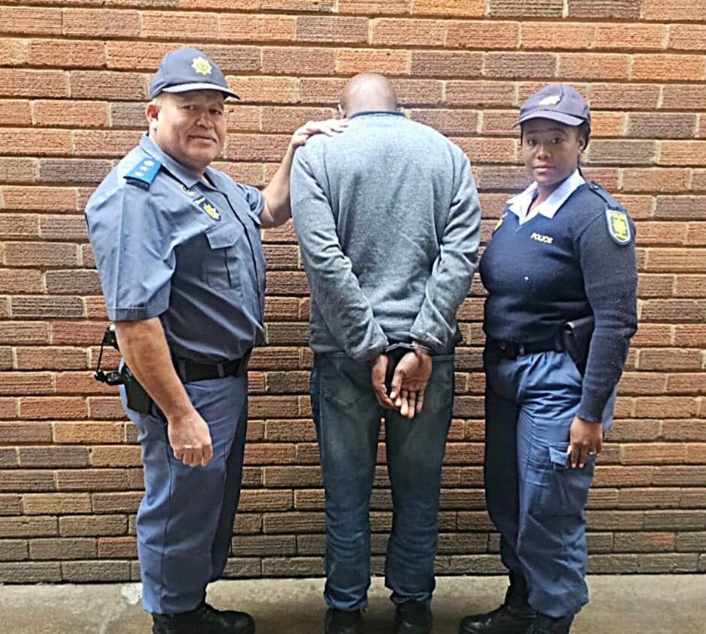 A 48-year-old man who reported a fake hijacking case (middle) with two police officers during the arrest. Photo supplied