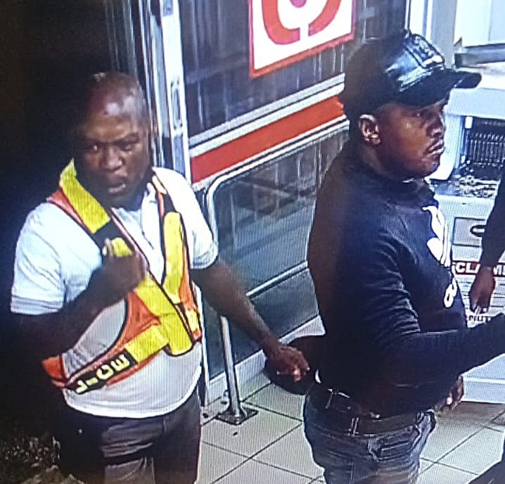 Two of seven suspects who were caught on camera during the robbery of the store.