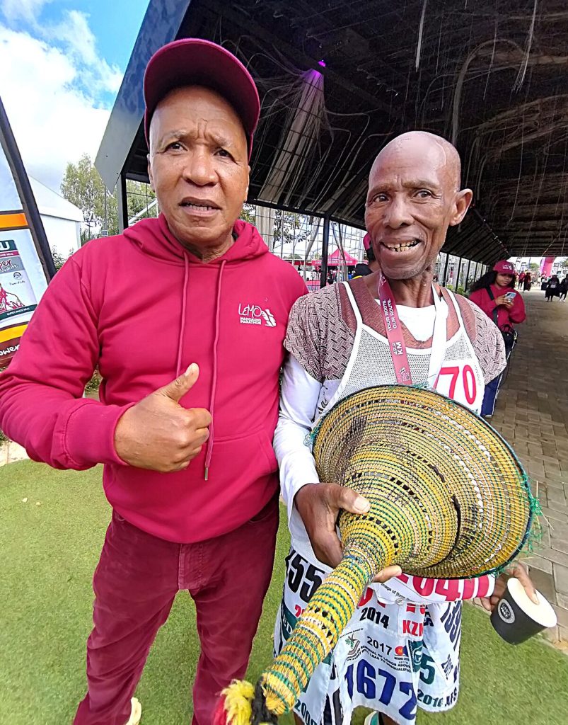 Mosotho May, who finished the marathon, is being congratulated by his peer Freddie Kenney, director of the Lemo Mangaung Marathon.  