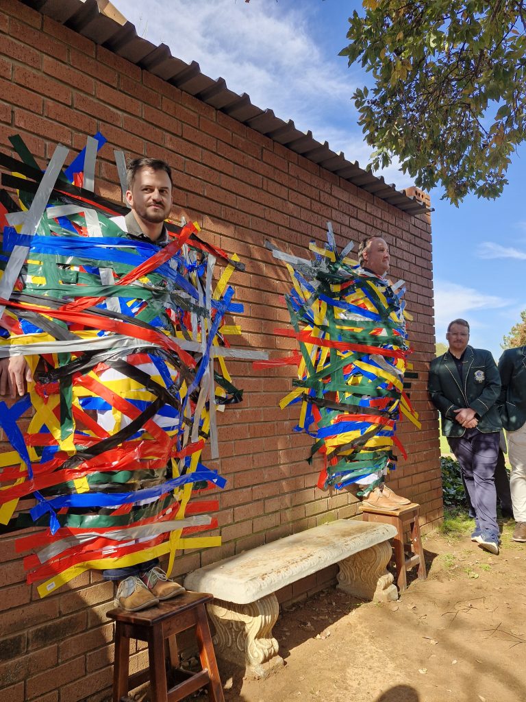 Teachers Barend Kriel (left) and Shane Marais was nominated to be stuck to a wall for charity.