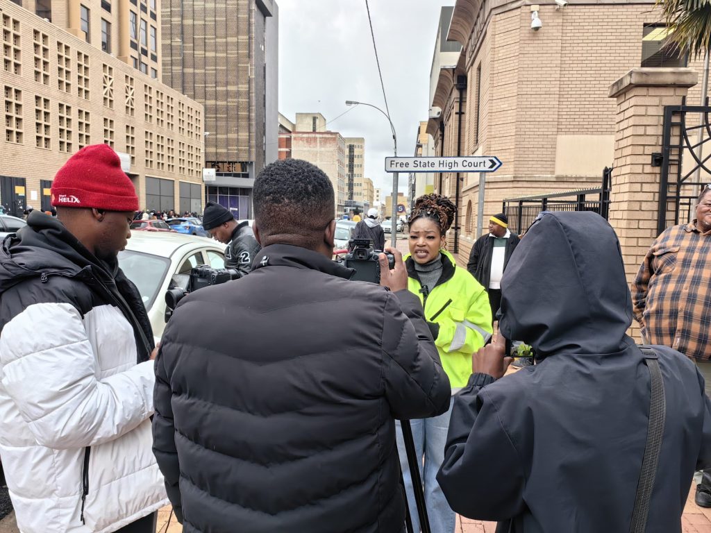 Ntombi Nhlapo, the Member of the Mayoral Committee (MMC) for Human Settlements in the Mangaung Metro, talking to reporters in front of the Free State High Court.