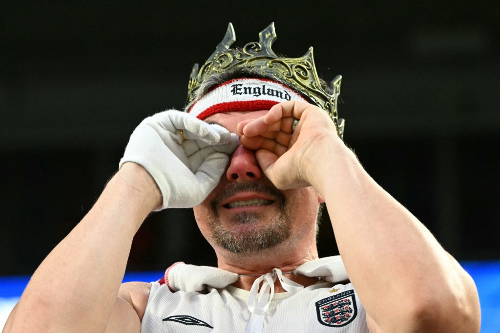 An England's fan wipes tears