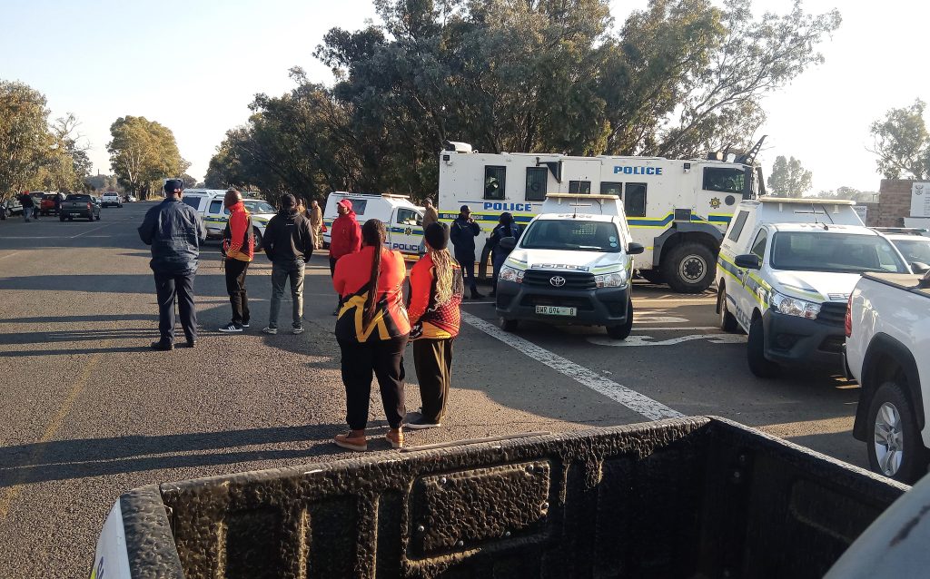 Police at the scene where workers were denied access to the prison.