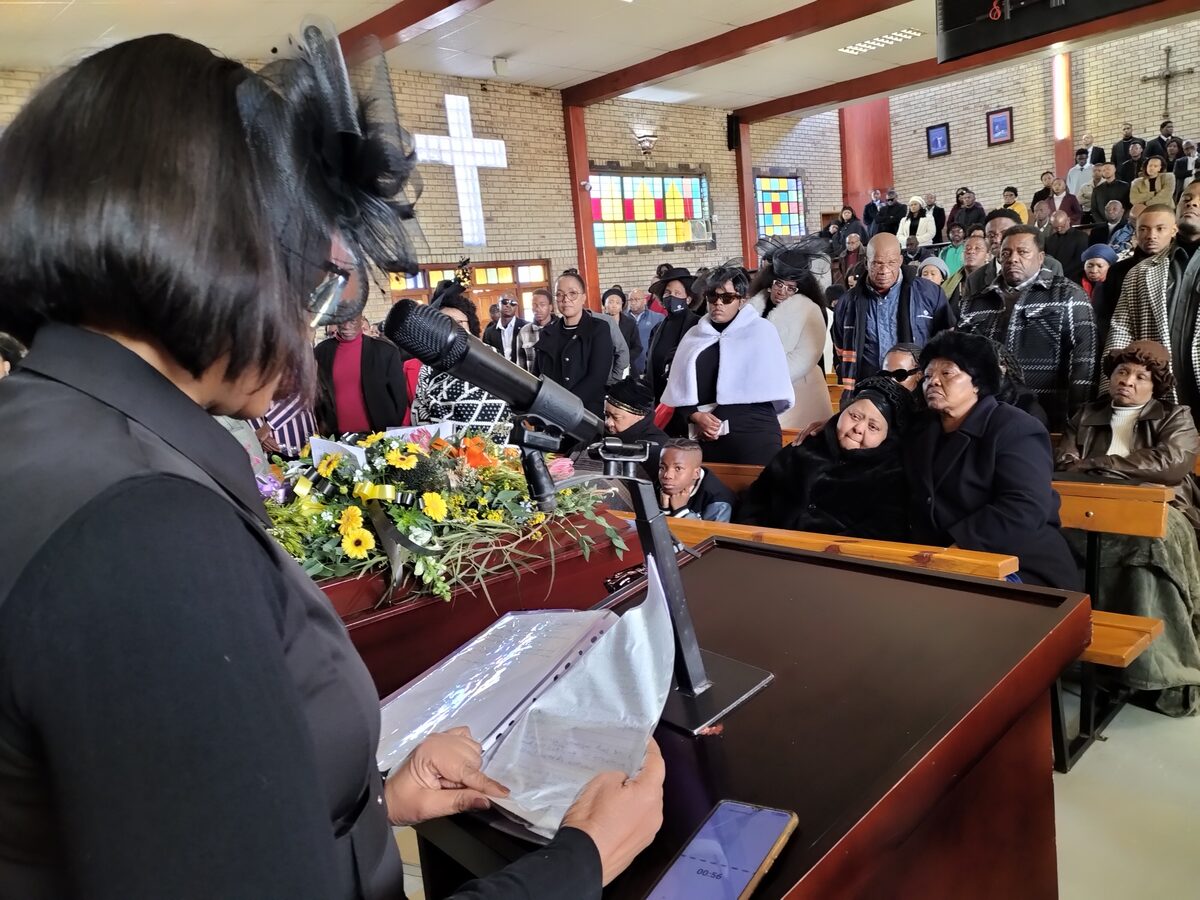 A tribute message written by Kgotso's mother, Mapheello (left front), is read to those in attendance