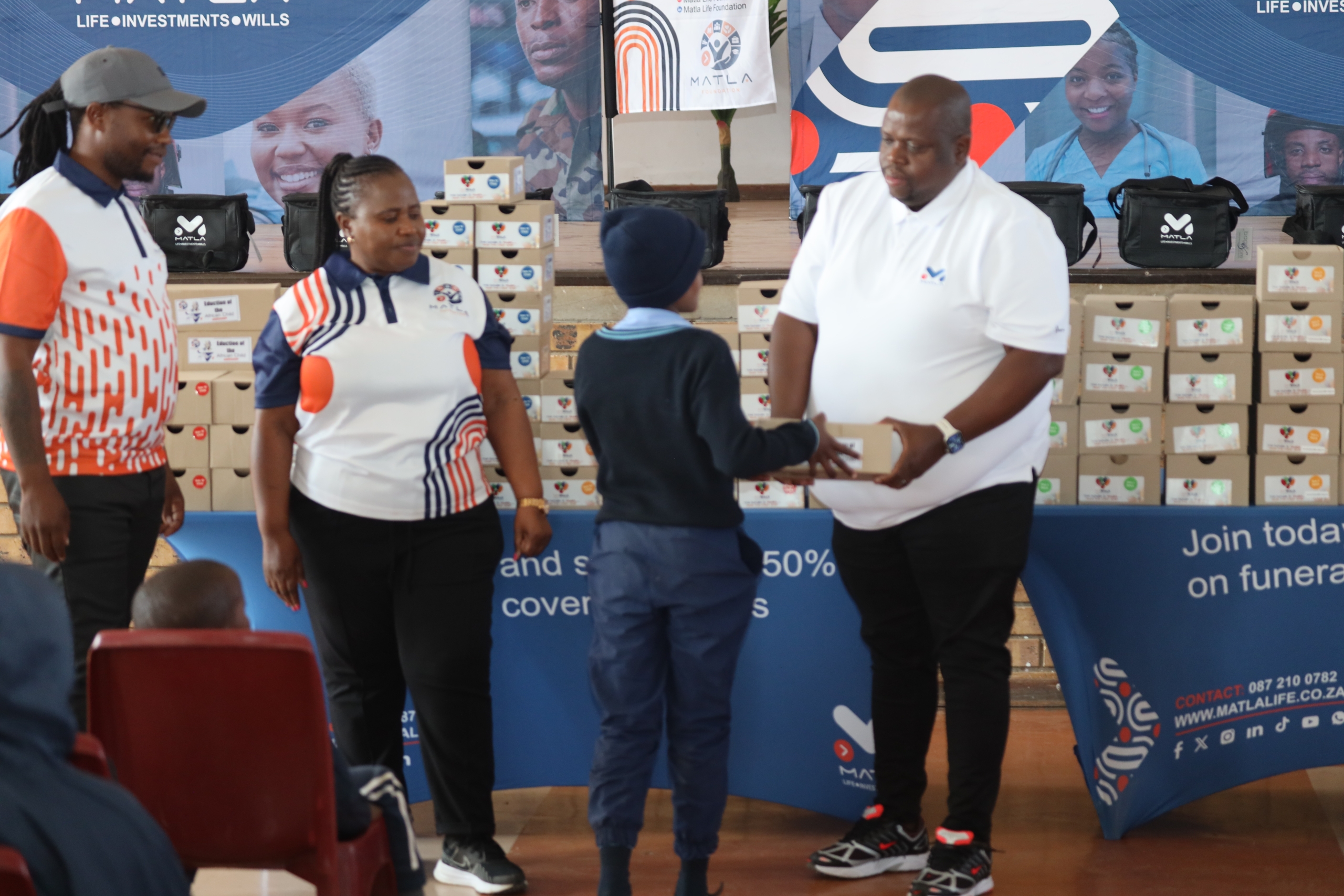 Learners receive shoes on Mandela Day Drive.