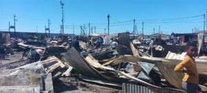 Fire victims scramble to rebuild their lives after blaze tears down more than 100 shacks in Philippi