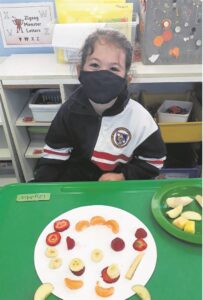 Local toddlers learn all about produce, sunflowers