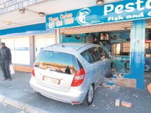 Driver ploughs into shop