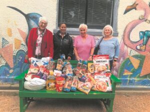 Women help stock Family Shelter pantry