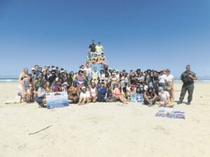 Stellenbosch University students do a clean-up of Strand Beach
