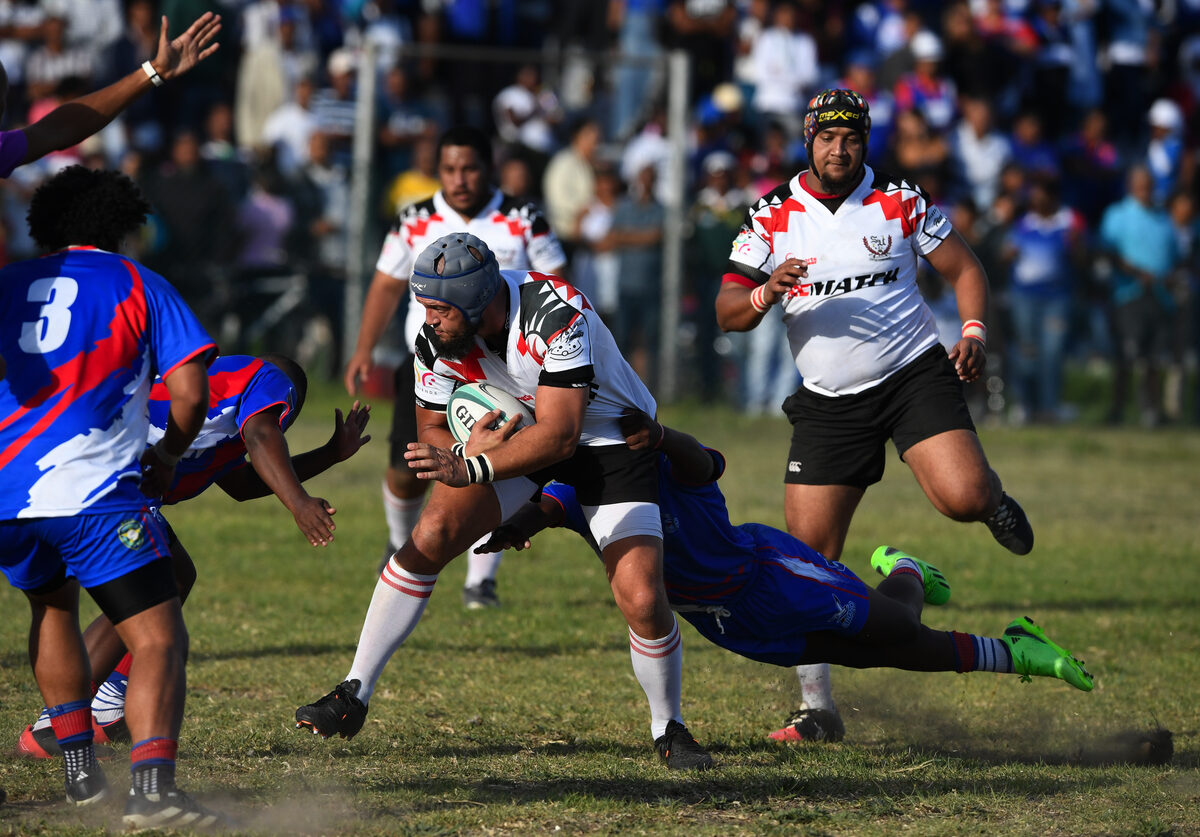 Playing for Strand United, veteran lock Yusuf Arnold protects the ball as he heads into Strand Rugby Club's defensive line during a Super League C derby encounter at the Abattoir Sports Ground on Saturday 26 April. Photos: Peter Bee.