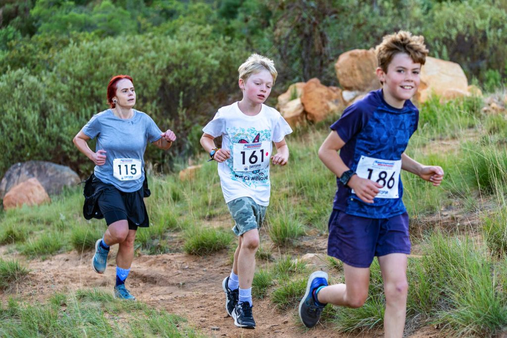 Runners participating in the Change of Season Trail Run on a forest trail at Dornier Estate, Stellenbosch.