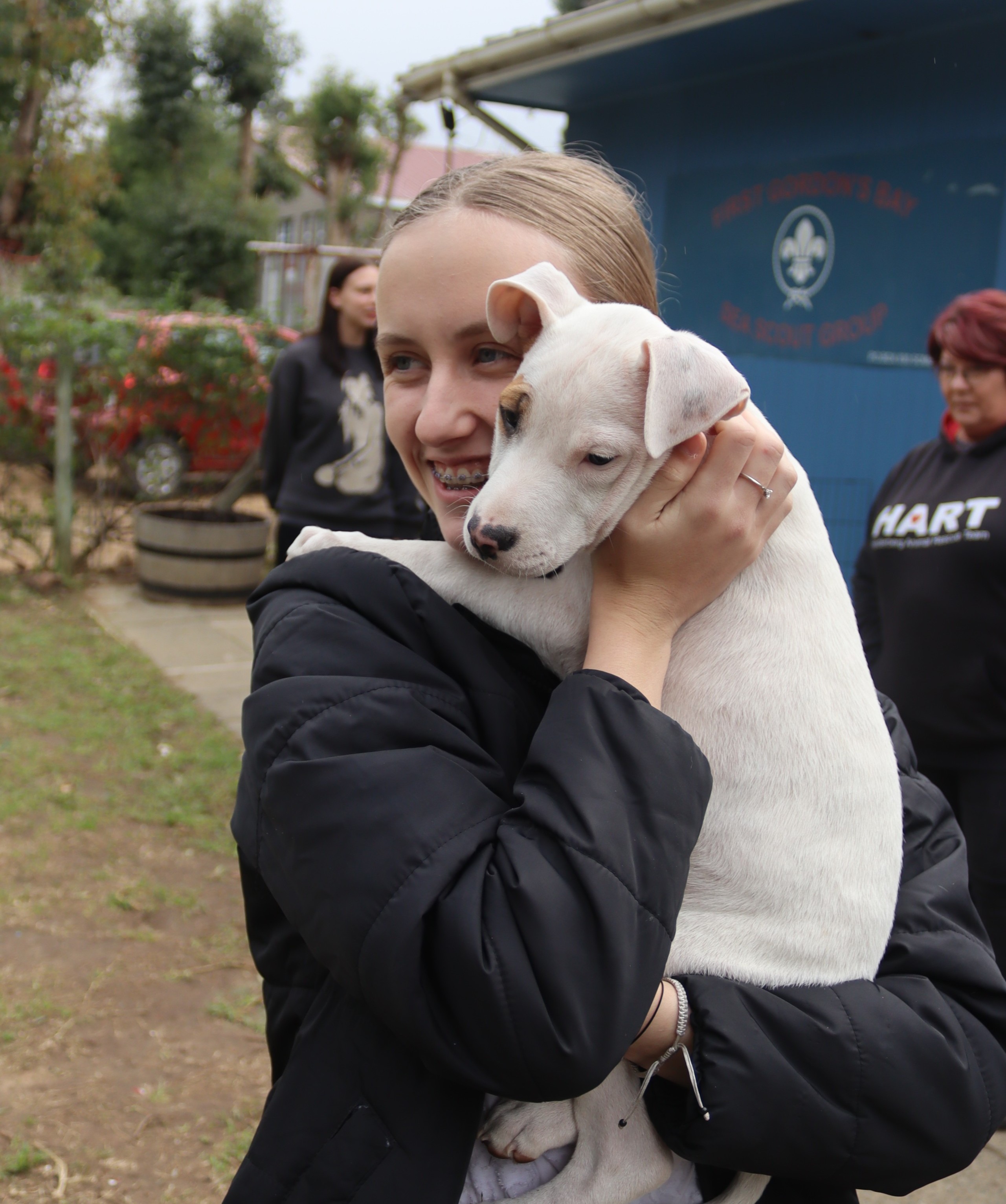 Mariette van Wyk snuggles with a rescue dog seeking adoption at HART's weekend adoption event in Somerset West.