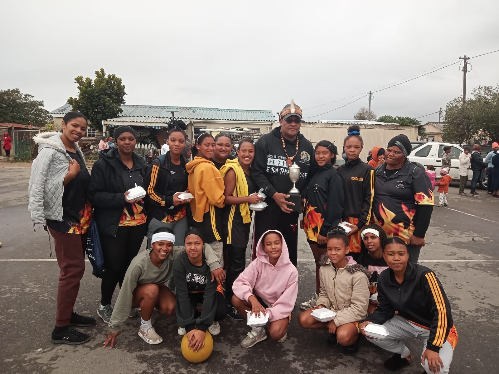 CIGK-takhoof David Jacobs oorhandig die beker aan die Young Stars, wenners van die Jeugmaand-netbaltoernooi in Strand