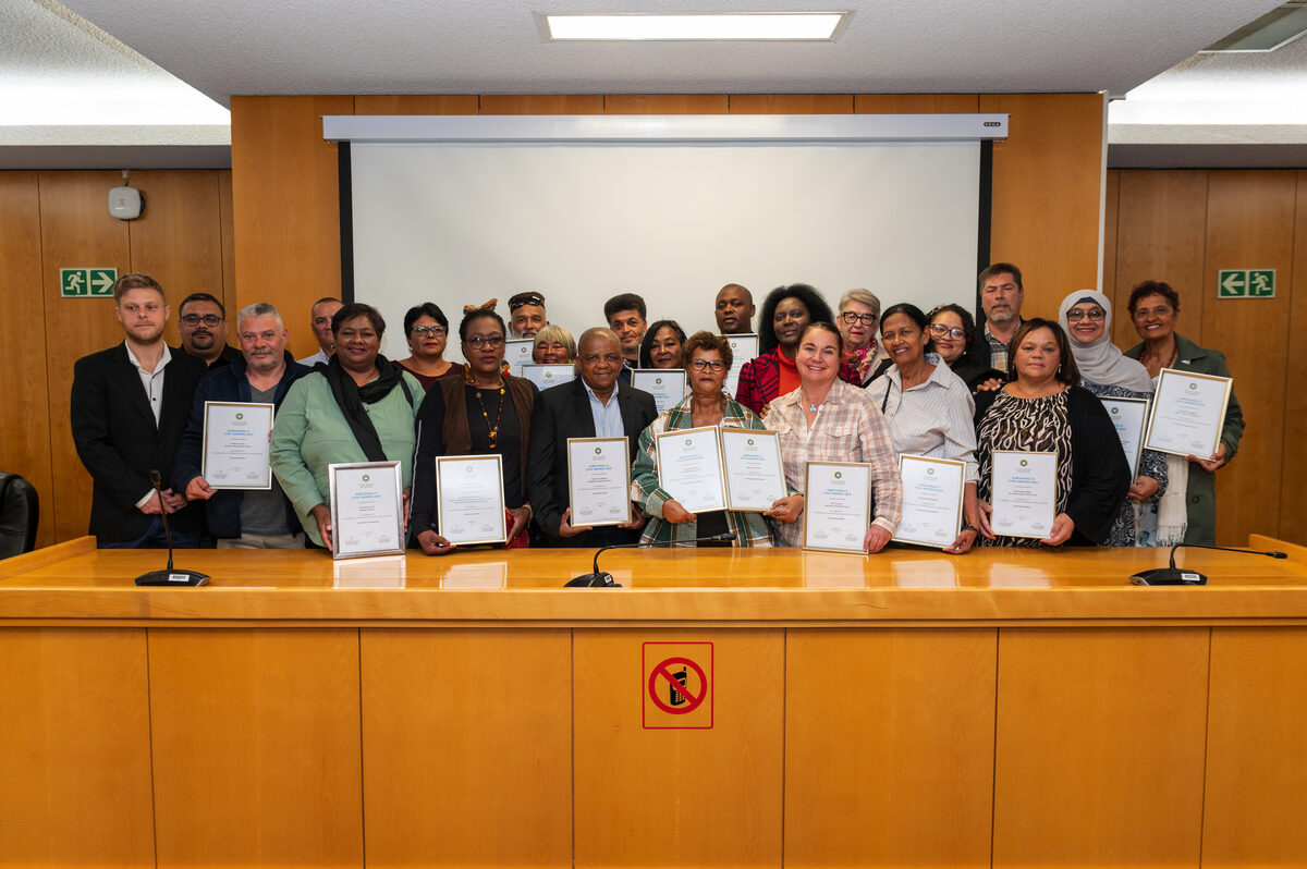 Community heroes at Strand Council Chambers receiving Civic Awards for their storm relief efforts in Cape Town.