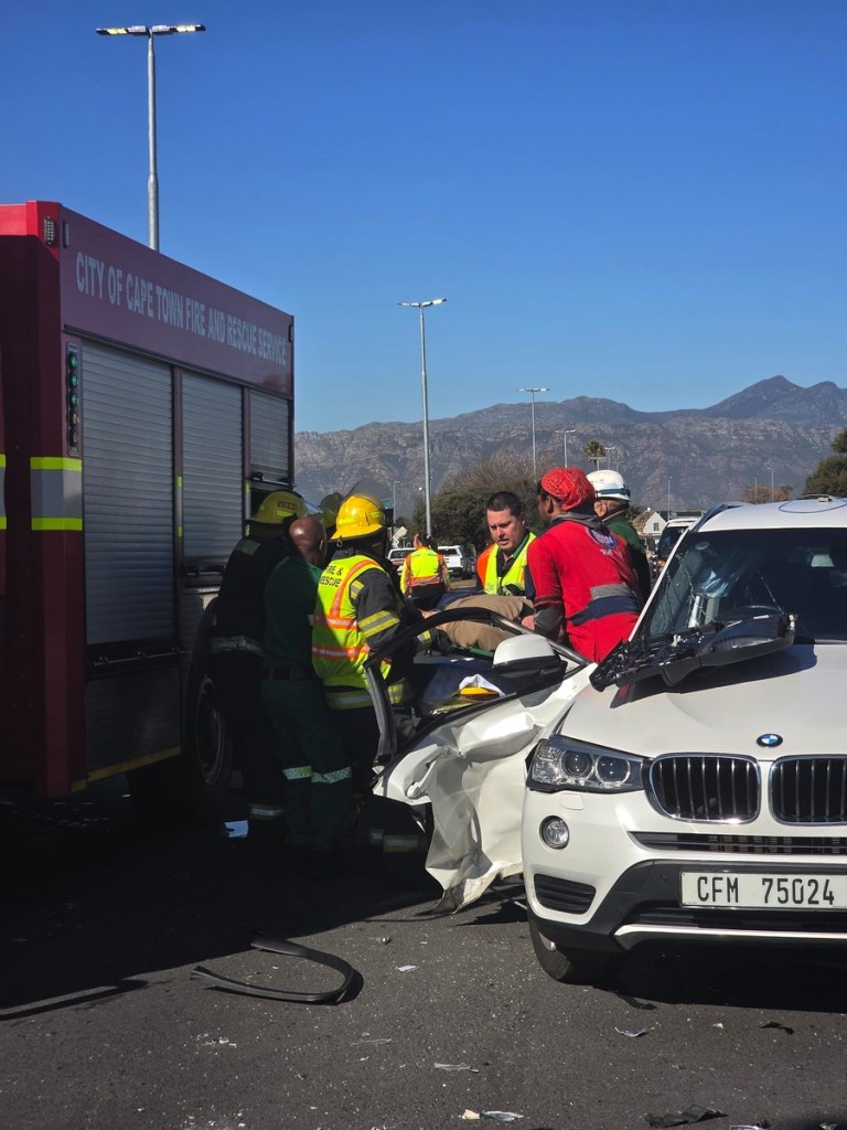 Emergency crews safely remove Chris Dicks from BMW and transfer to stretcher
