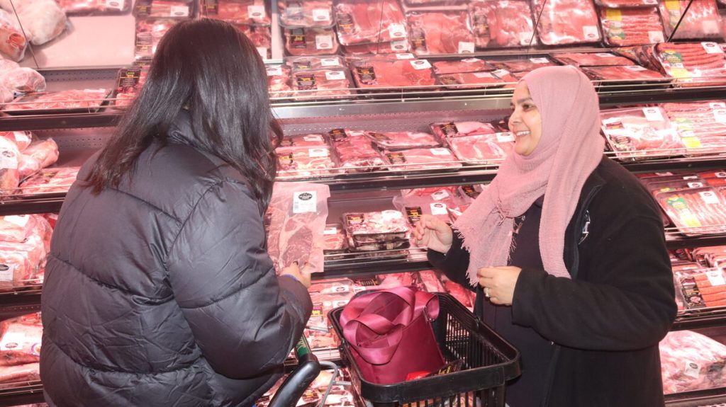TBM Strand store manager Imán Calvert shows customer Elaine Titus a beef rump steak