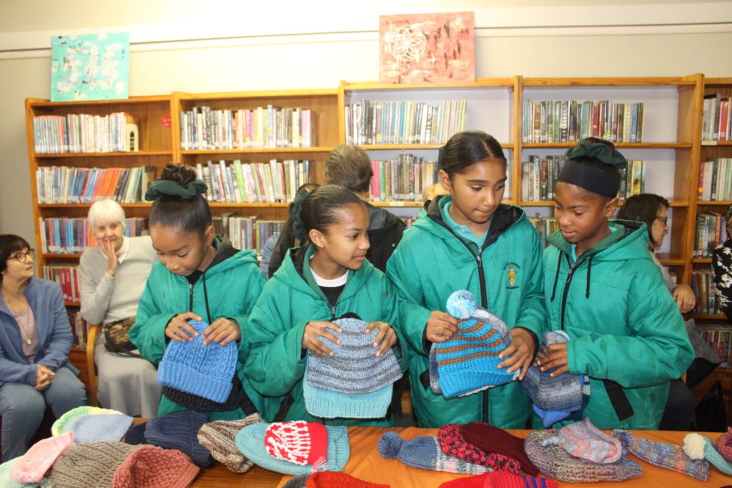 Drummies from Dr GJ Joubert School select beanies at Gordon's Bay Library Mandela Day event