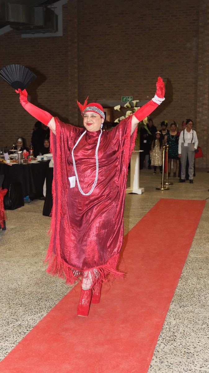 Amina Peters participates in the modeling show wearing impressive Great Gatsby attire.