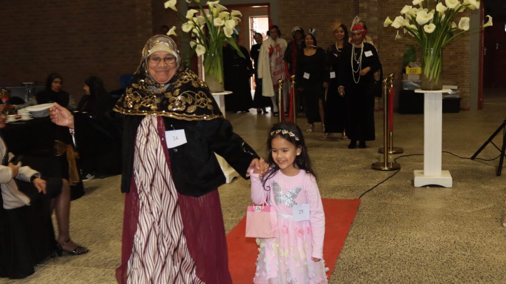 asmina Anthony and Maryam Peters walk the red carpet during the fundraiser's modeling show.