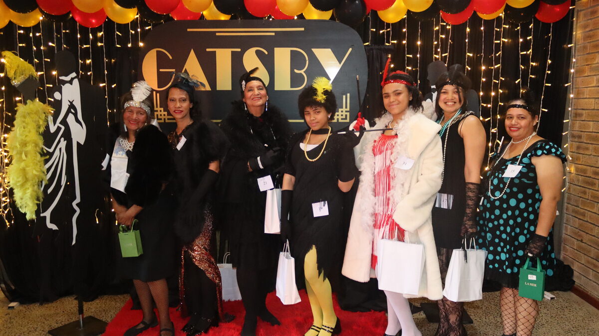 Winners of the Great Gatsby-themed modeling show dressed in glamorous 1920s fashion and attire.