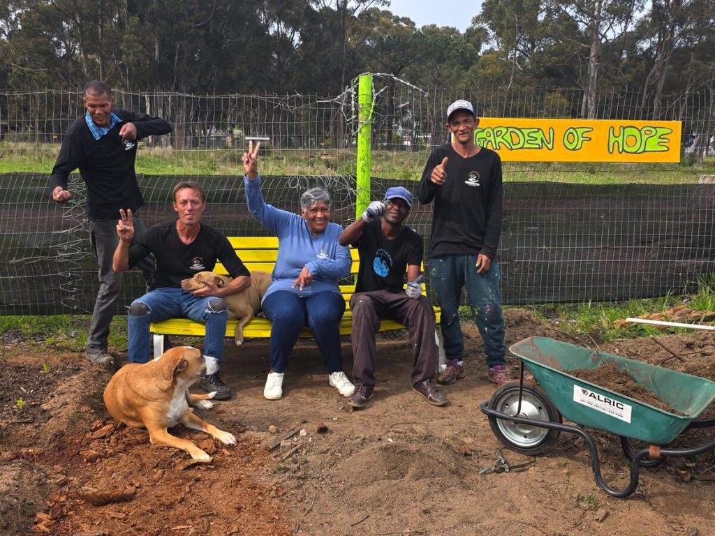 Staff standing in Helderberg Omgee's Garden of Hope vegetable garden used for recovery programmes