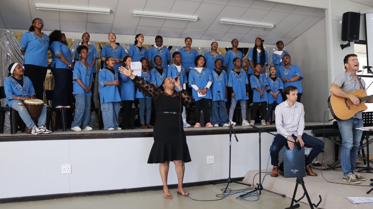 Hope and Light school choir, ECD teacher Lezl Rooi, and school band performing at anniversary service