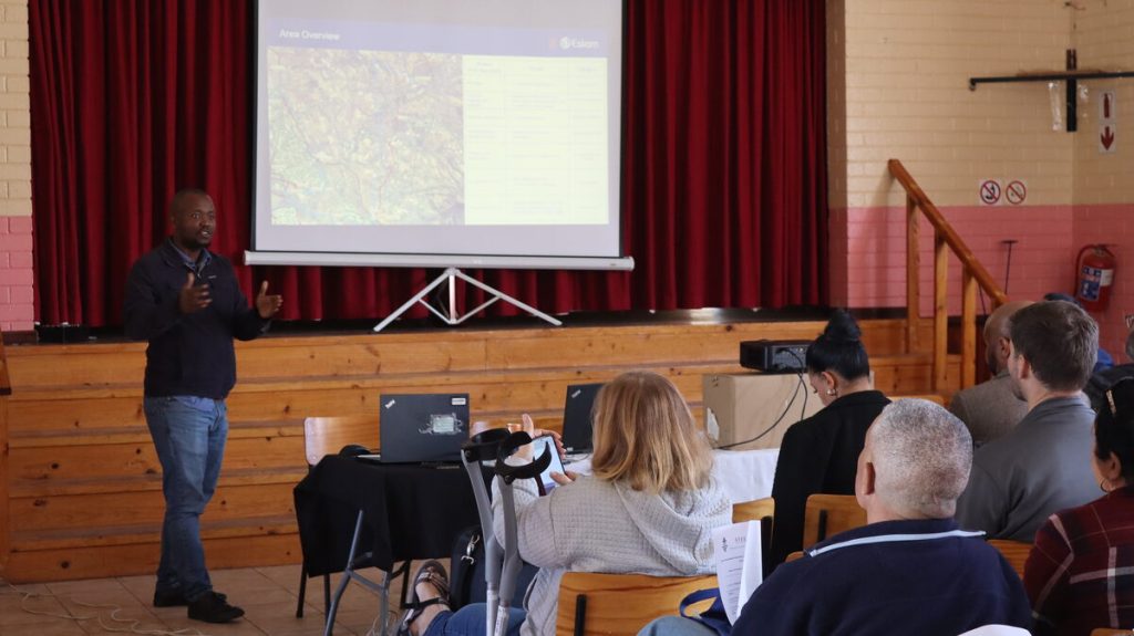 Sicelo Ngxonono, Eskom's senior network planning advisor, presents infrastructure development plans to Raithby residents during his PowerPoint presentation. Photo: Barend Williams
