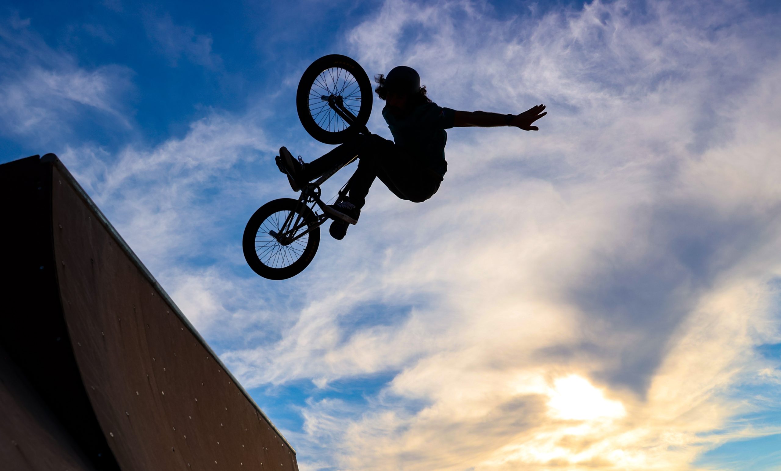 Vincent Leygonie, professional freestyle BMX rider of Team South Africa unpacks and performs some tricks inside the team hotel in Montpellier, France. Photo by Roger Sedres/TeamSA