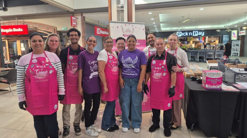 Volunteer Cupcake Angels selling home-baked cupcakes for cancer charity fundraising at Waterstone Village