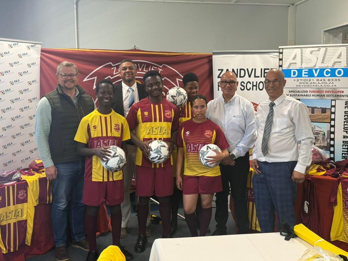 At the hanover of soccer equipment to Zandvliet, back row: Pierre Blaauw, Idrees Apollis Mervin Green, and Lester Hendricks. Front: learners: Moses Makubelo, Elie Kasagwe, Zachary Lindt, and Christen Samuels.
