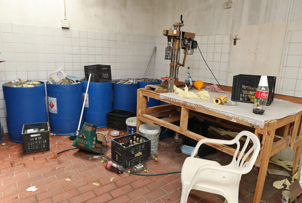 Bottling and capping machine seized by police during raid on illegal alcohol factory at Faure farm