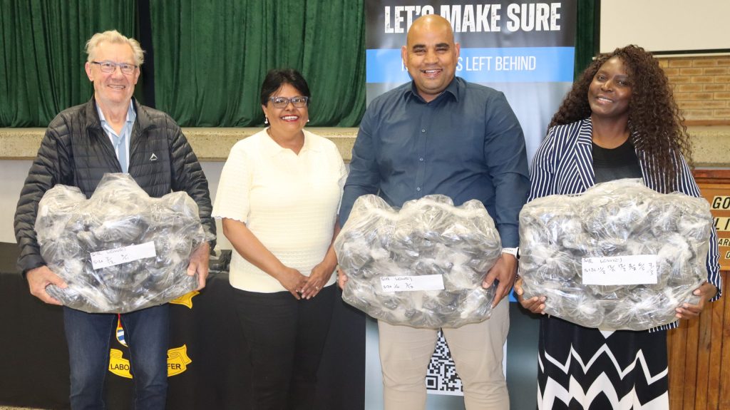 Ward 84 councillor Norman McFarlane accepting eco-friendly shoes on behalf of Sir Lowry's Pass Primary School