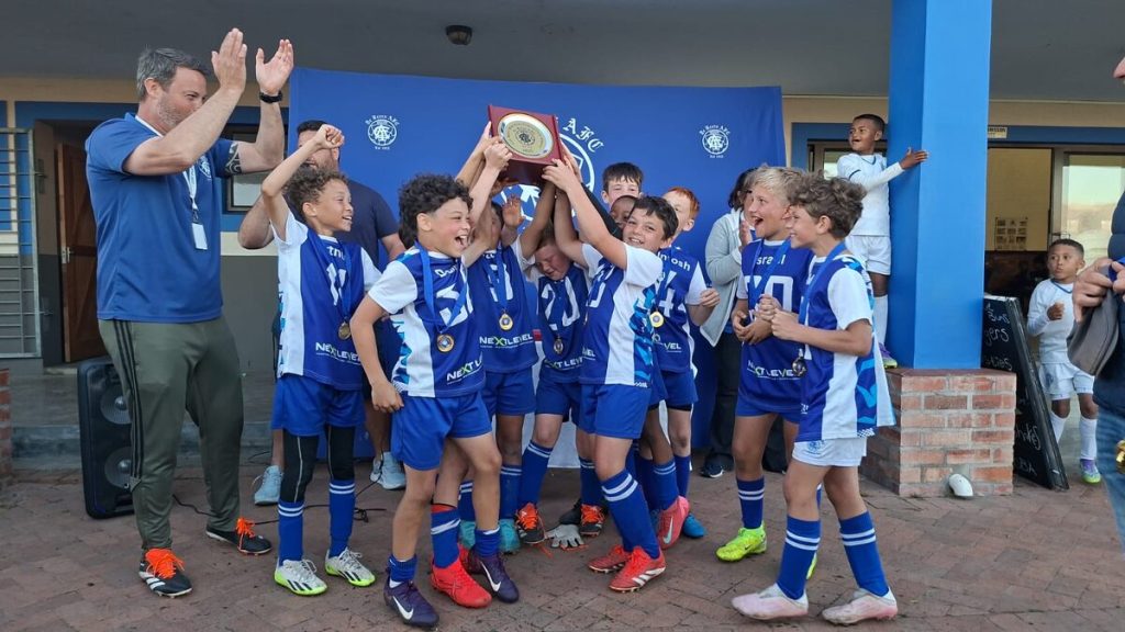The u-10 mini team of De BeersA FC celebrating a tournament win during the season.