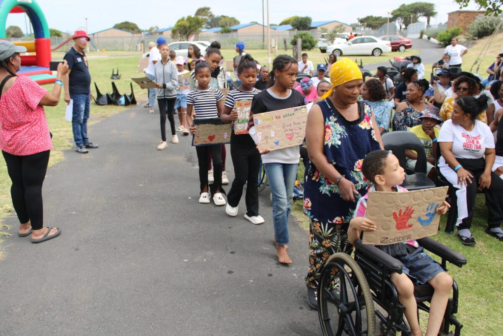 Children held up placards expressing love following the Ministers arrival.