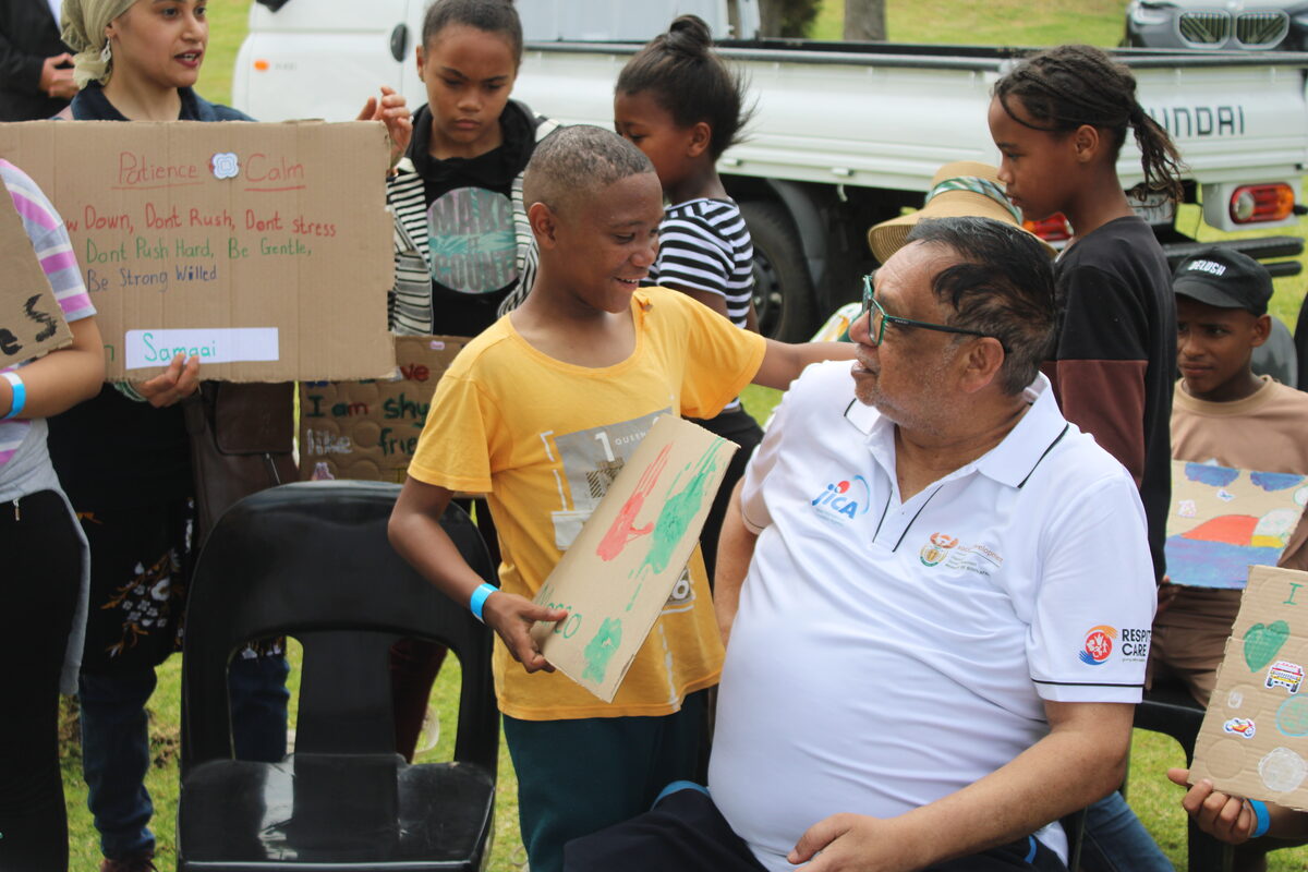 Deputy minister Hendricks shares a moment with a young child.