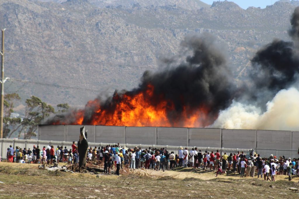 Large flames spewed massive columns of black smoke from the Broadlands Road industrial area.
