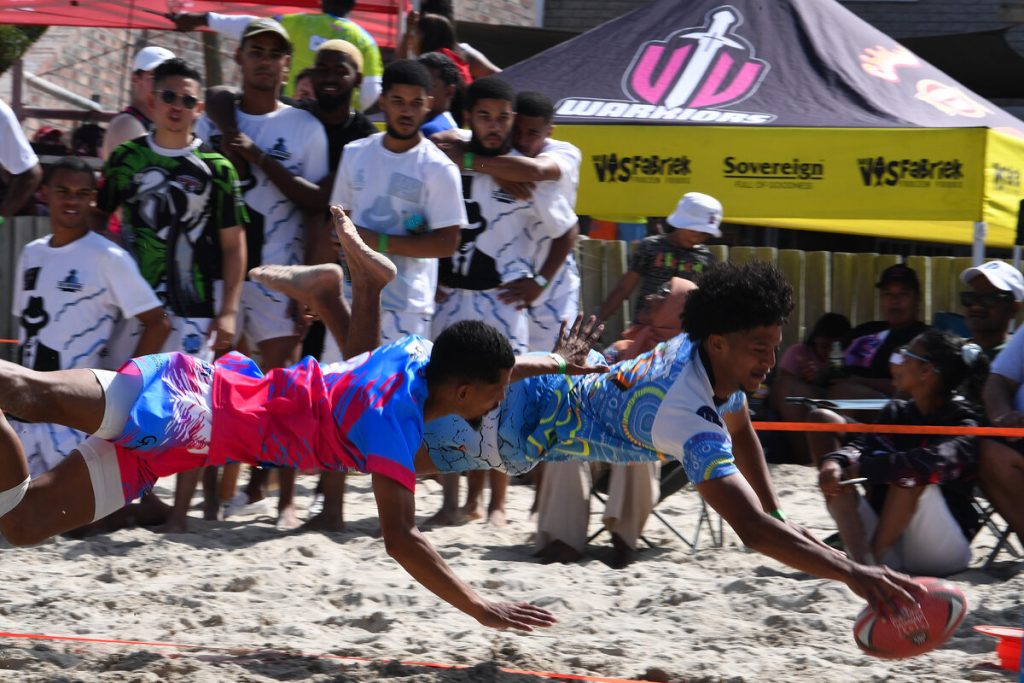 Jaiden Faviers scores a try for Most Wanted despite a tackle by Keyano Flandorp of OJK Underdogs during the Strand leg of the Hot Summer of Touch series. 
