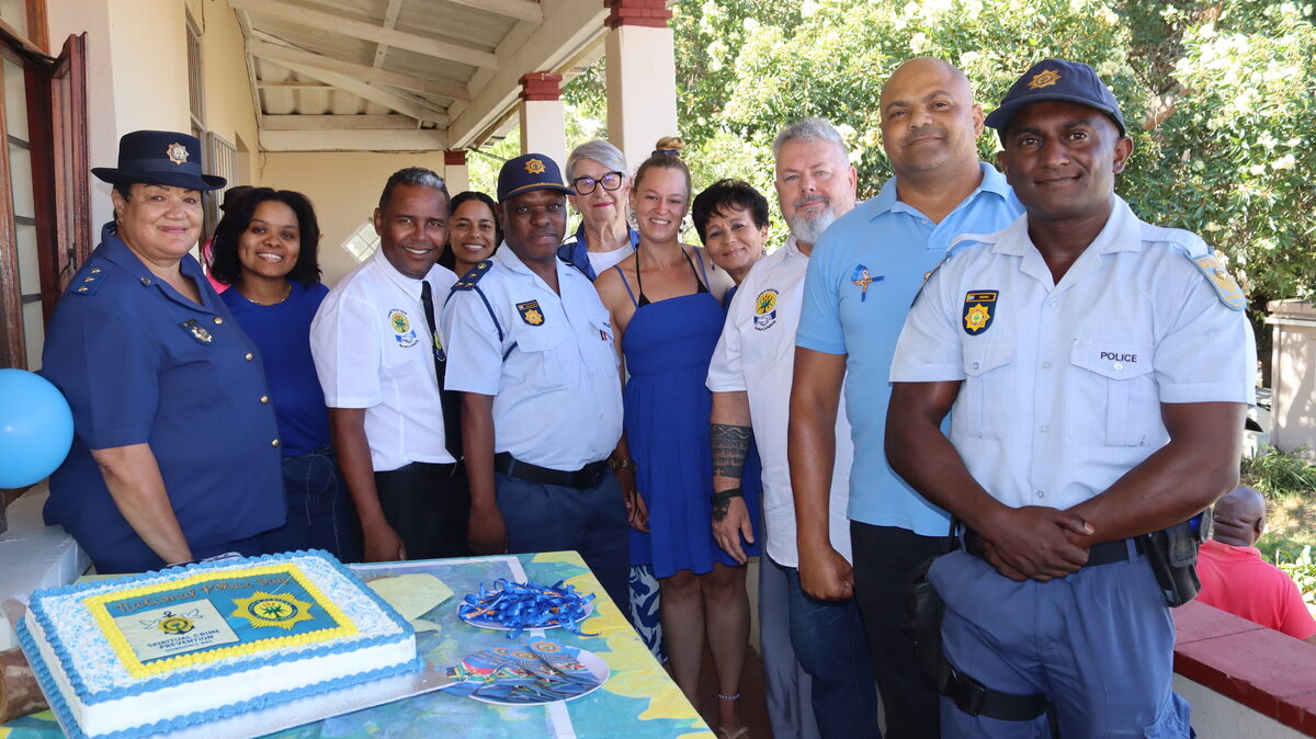 Police officers and local residents in formal group photo