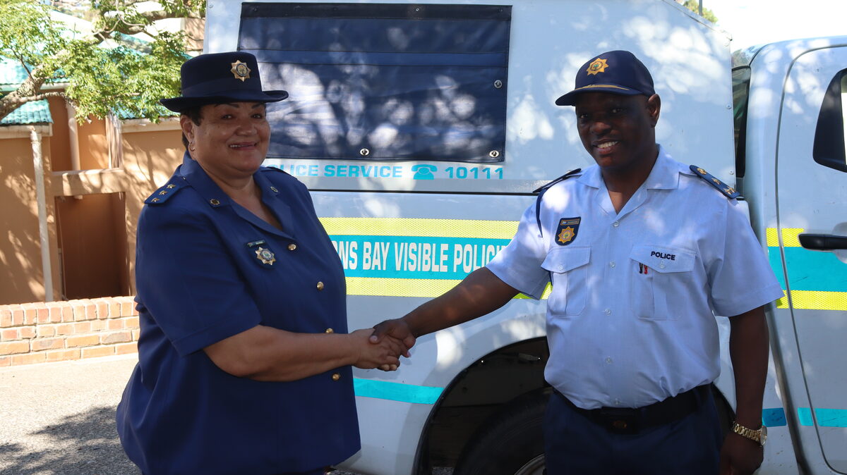 Police captain and brigadier greeting each other warmly
