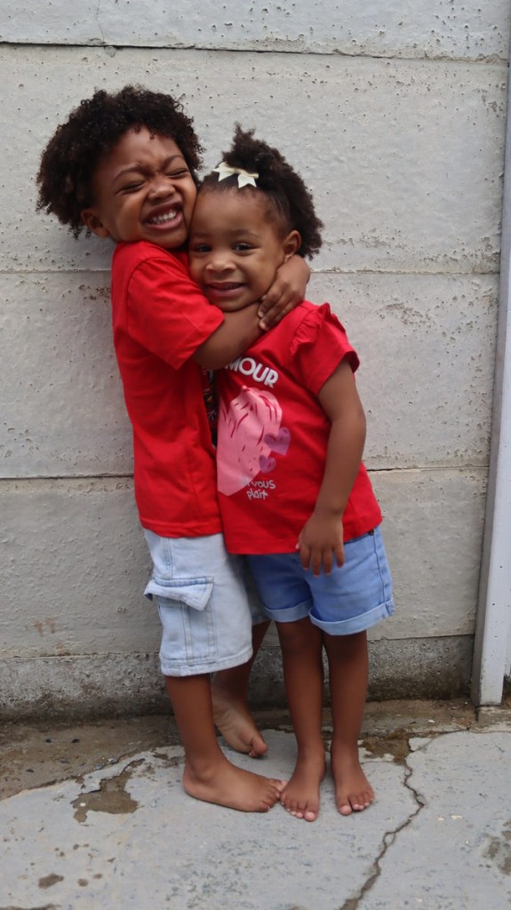 Siblings Rayhano Philander and Naeelah Malgas share a warm, playful hug in the Helderberg
