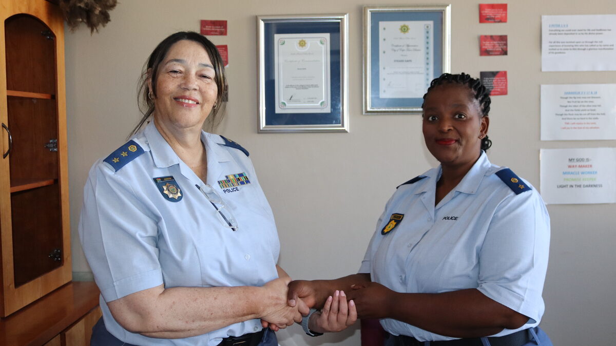 Col Jacqui Johnson and Lt Col Noxolo Rulwa shake hands at Strand police station