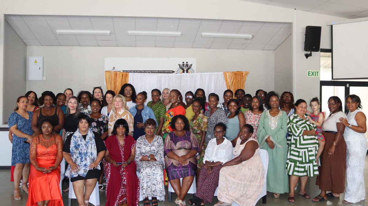Group of 53 women seated in school hall attending women's empowerment event in Somerset West