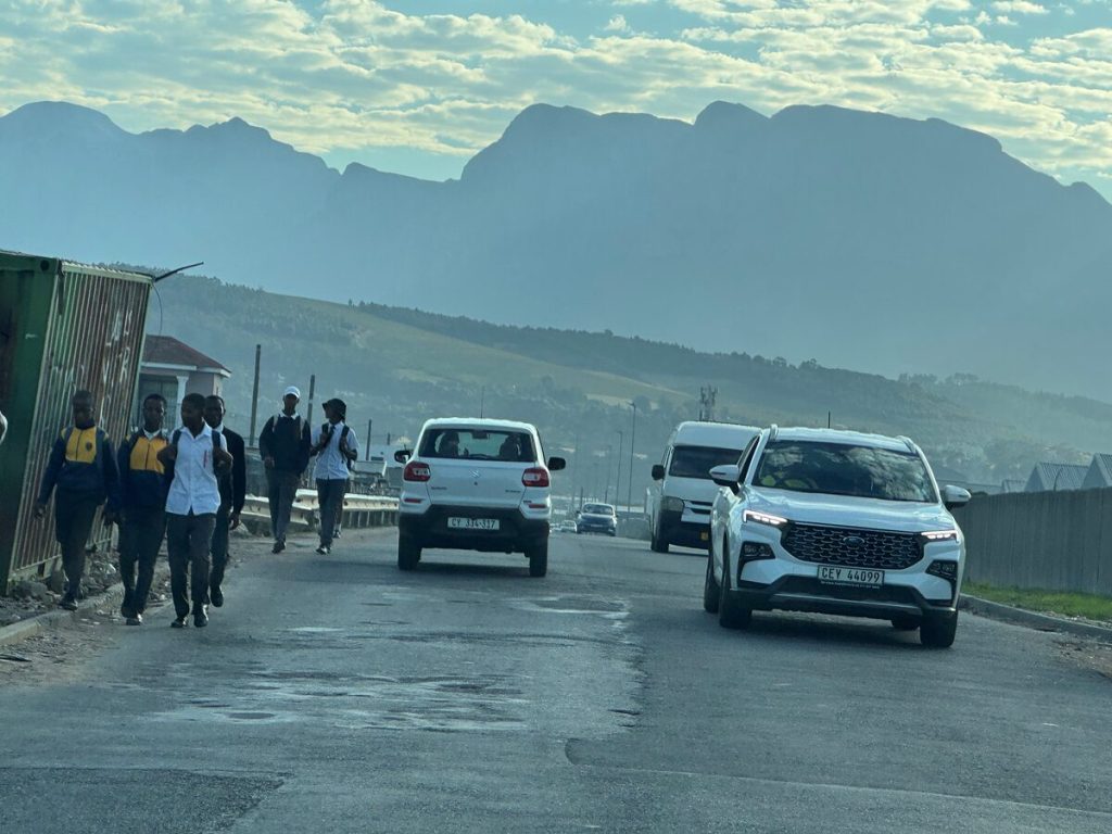 The lack of a sidewalk along Broadlands Road in Strand forces pedestrians onto the tarmac when commuting to work and school. Photo: Yaseen Gaffar