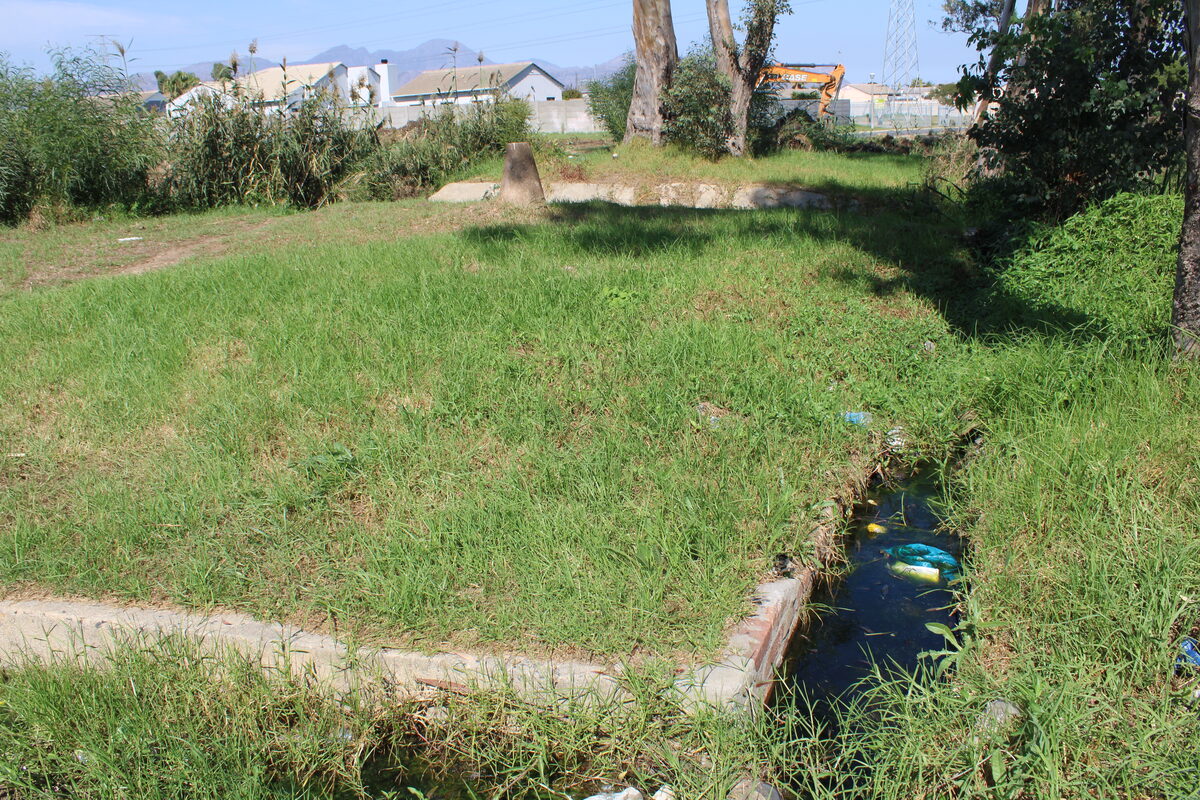 The concrete canal, filled with stagnant water and waste materials has been left uncleaned for several weeks.