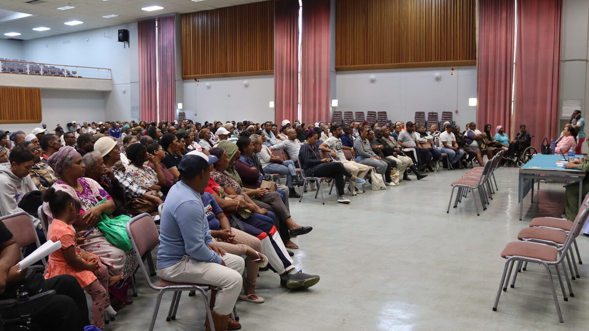 Crowded town hall filled with residents attending housing committee election meeting